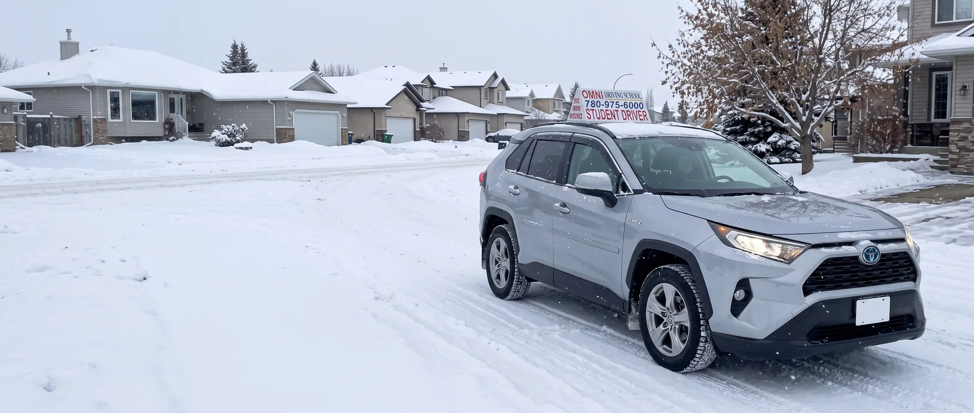 The Omni Driving School car on a snowy street of houses in winter
